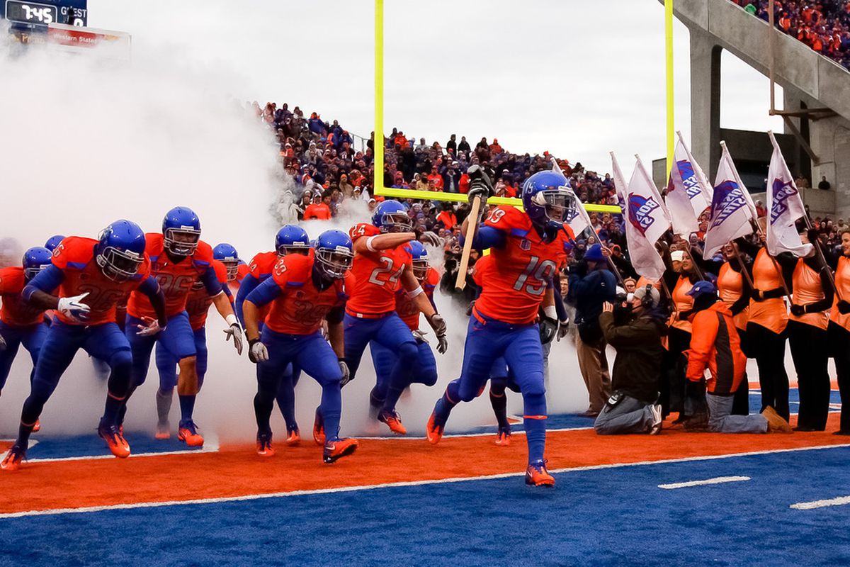 BOISE, ID - DECEMBER 03:  Josh Borgman #19 of the Boise State Broncos carries the hammer onto the field before the game against the New Mexico Lobos at Bronco Stadium on December 3, 2025 in Boise, Idaho.  (Photo by Otto Kitsinger III/Getty Images)